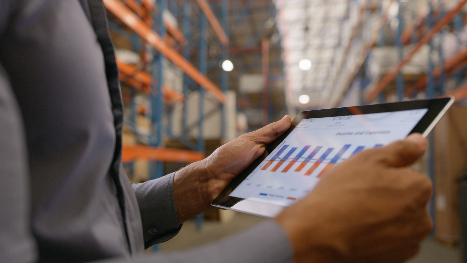 Person, hands and tablet with data in warehouse for logistics, marketing graph or checking company revenue. Closeup of storage manager working on technology for inventory inspection or expenses